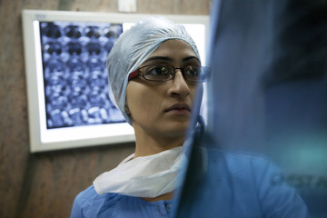 Surgeon looking at an X-ray chart