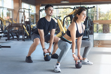 Fototapeta na wymiar Young couple exercise together in gym healthy lifestyle