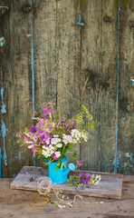 Fototapeta na wymiar Wild field flowers bouquet over wooden background