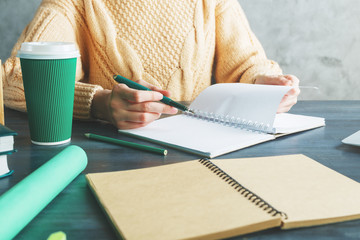 Woman writing in notepad
