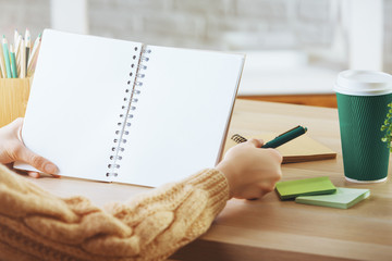 Female writing in empty notepad