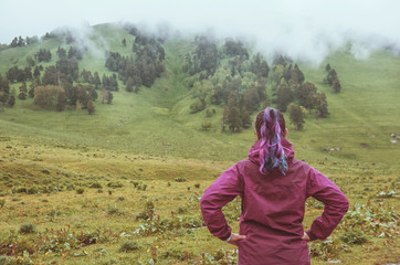 Woman looking on foggy valley. Tourism concept
