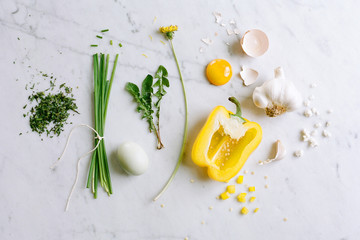 Arranged omelette ingredients on marble