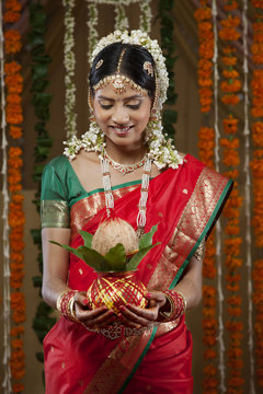 Smiling bride holding kalash 
