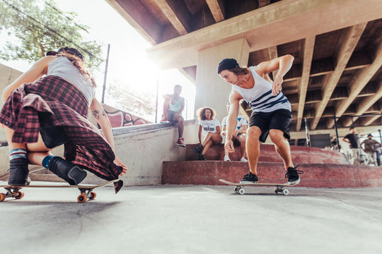 Young people skateboarding at skate park