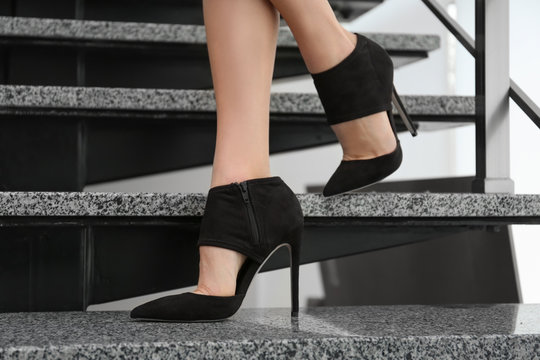 Female legs in stylish shoes on stairs