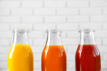 Delicious juices in bottles, closeup