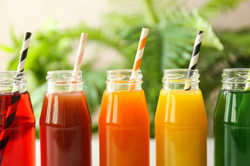 Delicious juices in bottles, closeup