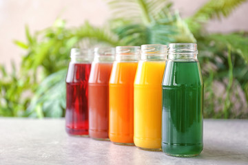 Delicious juices in bottles on table