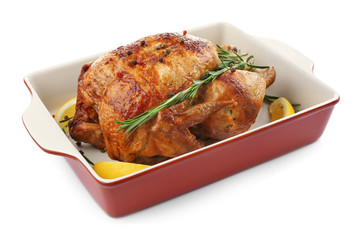 Baking dish with tasty homemade lemon chicken on white background