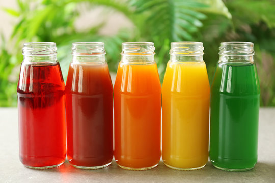 Delicious juices in bottles on table