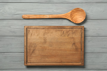 Board and spoon on wooden background