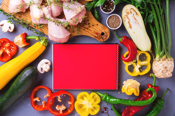 Raw chicken thighs with various vegetables ingredients. Top view.