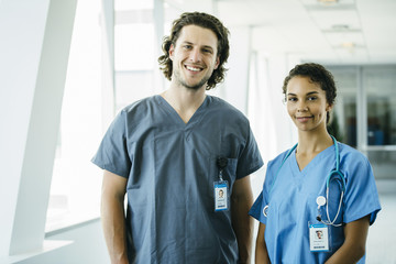 Portrait of Male and Female Nurses in Hospital Hallway