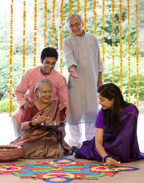 Family making a rangoli 