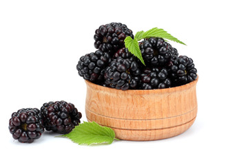 blackberries in wooden bowl isolated on white background