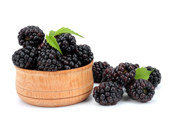 blackberries in wooden bowl isolated on white background