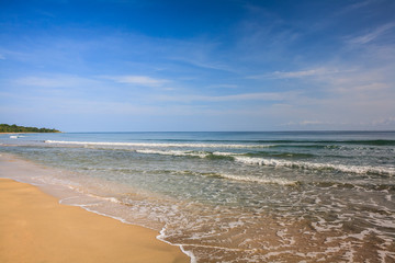 Fototapeta na wymiar Waves on a Sandy Caribbean Beach