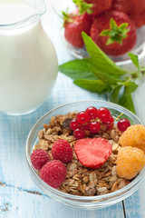 Healthy Breakfast cereals muesli with fruits and berries strawberries, raspberries and red currants with dairy products. Selective focus.