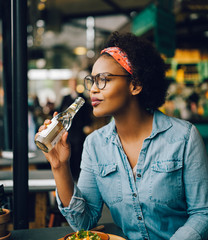 Smiling young woman enjoying dinner in a bistro