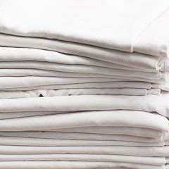 Fototapeta na wymiar Stack of white folded cotton tablecloths