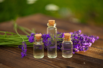 Essence of lavender flowers on table in beautiful glass jar