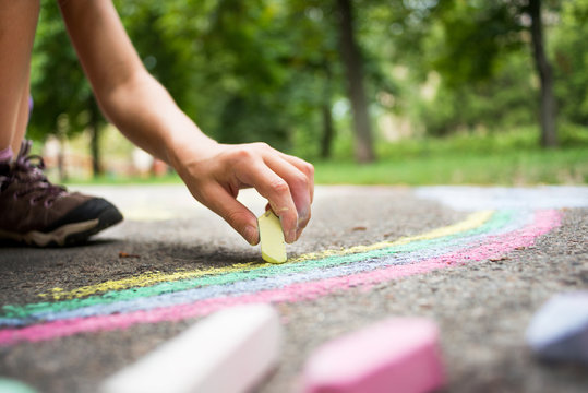 Little girl holding crayons in hands