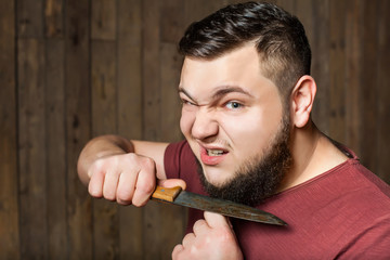 brutal man shaving with knife