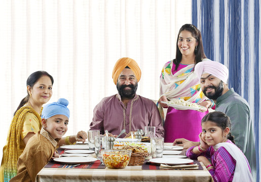 Sikh family having lunch at the dinner table 