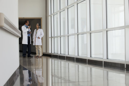 Two doctors talking in hospital corridor