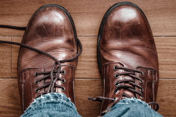 Close-up of leather two boots with untied laces view from above