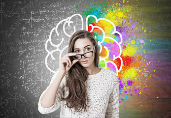 Young woman taking off glasses, brain, formulas