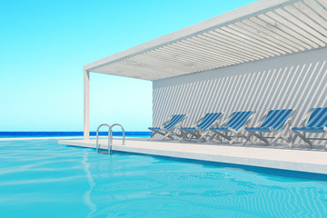 Swimming pool with blue deck chairs, ocean