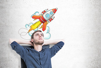 Pensive man in armchair, start up rocket