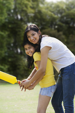 Mother and daughter playing cricket 