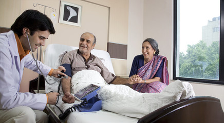 Doctor checking a patient's blood pressure 
