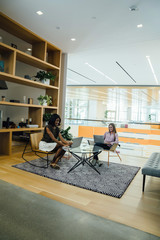 Female business professionals meeting in modern office space