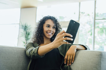 Woman taking selfie on cell phone