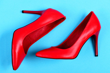  Formal red high heel shoes isolated on blue background