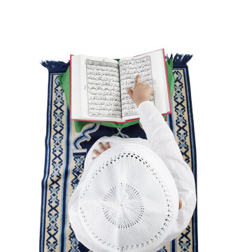 Muslim boy reading the Quran 