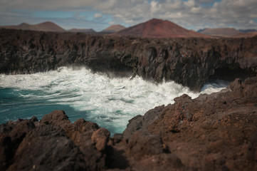 Tilt shift effect of fringing waves on rocky coastline, Los Hervideros, Lanzarote, Canary Islands