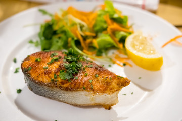 Salmon Steak with Vegetable, served on plate in the restaurant
