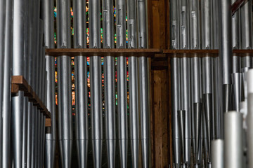 part of the church organ with many air pipes made of metal