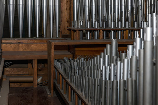 part of the church organ with many air pipes made of metal