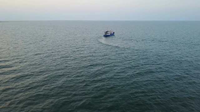 Fishing boat in the Azov Sea at sunset. aerial survey