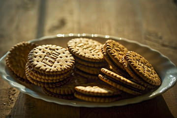 Hit golden biscuit sandwich filled with chocolate cream on the plate 