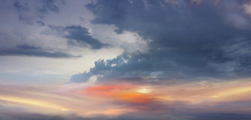 Plakat Dramatic colorful sky. Light in dark sky . beautiful cloud . Fiery orange sunset sky 