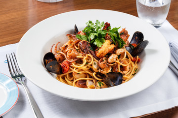 spaghetti sea food on white plate.