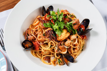 spaghetti sea food on white plate.