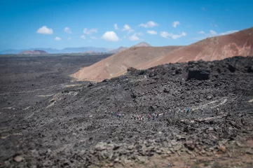 Foto op Canvas Tilt shift effetc of tourists walking on ancient lava flow, Lanzarote, Canary Islands © Gianluca